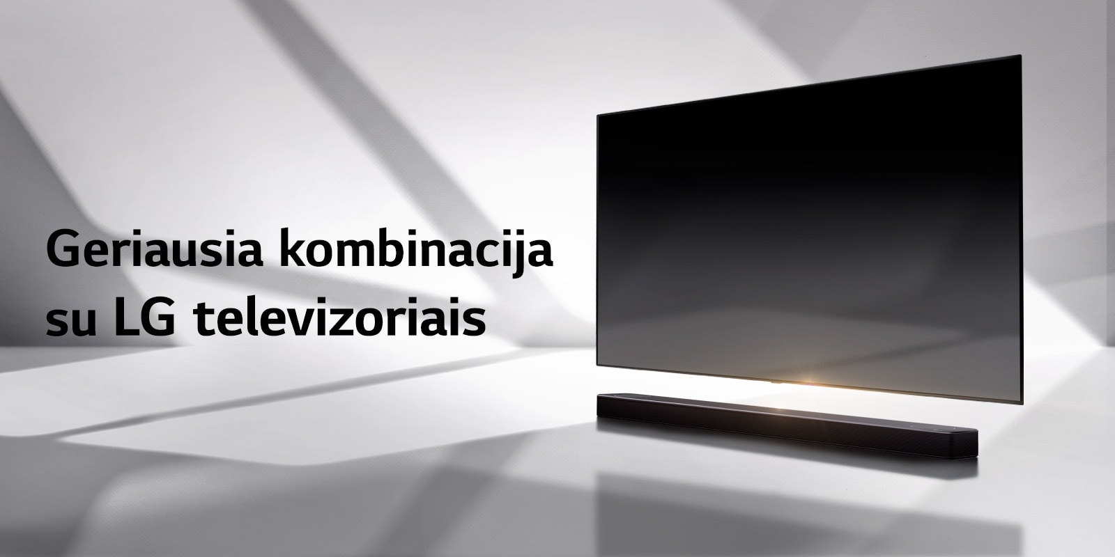 Horizontalusis garsiakalbis ir televizorius pastatyti ant balt? grind?, o u? j? krenta ?e??lis i? lauko.