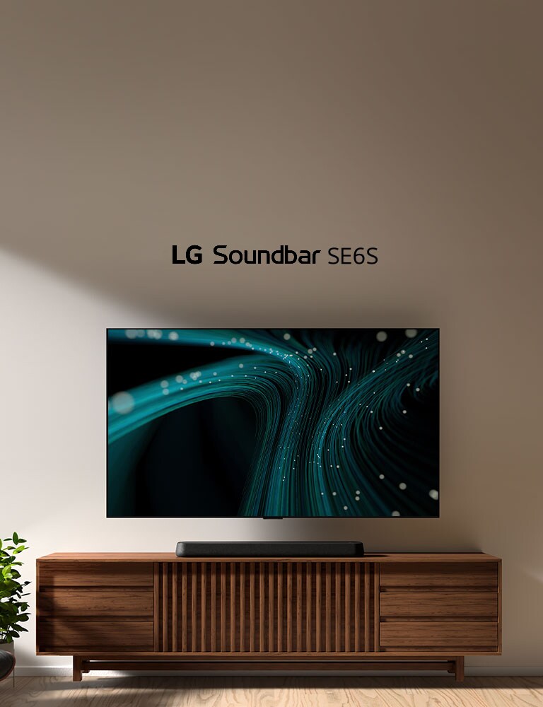 LG Sound Bar SE6S er plassert p? treskapet. Over en veggmontert TV med bl? lydb?lgebilder og prikkete lys er plassert. P? venstre side ser man litt av et vindu og en stol i svart skinn er plassert foran en gr?nn plante.