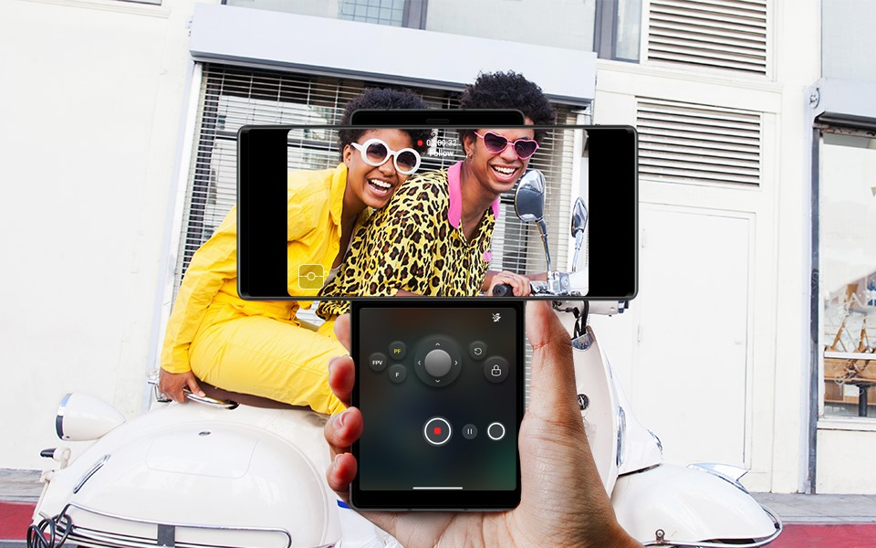 A person recording two people with the LG WING's gimbal motion camera feature