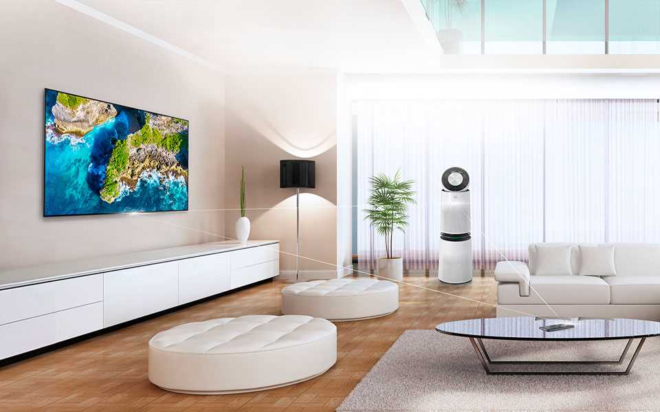 An LG PuriCare? Air Purifier and OLED TV on display in a living room with seating.