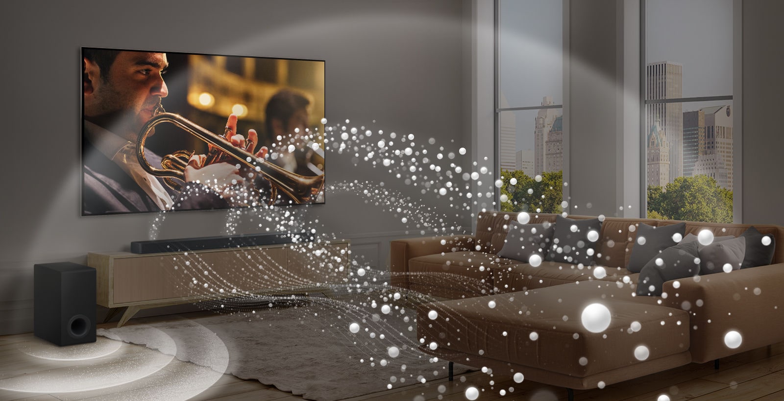 LG Soundbar, LG TV a subwoofer sú v modernom mestskom byte. Z panela LG Soundbar vychádzajú tri vetvy zvukovych v?n, tvorené bielymi kvap??kami, ktoré plynú pozd?? spodnej ?asti podlahy. Z hornej ?asti soundbaru sa ?íria ?al?ie biele zvukové vlny vo forme kvap??ok. Ved?a soundbaru sa nachádza subwoofer, ktory vytvára zvukovy efekt zospodu. Spolo?ne vytvárajú kupolovy efekt v celej miestnosti.